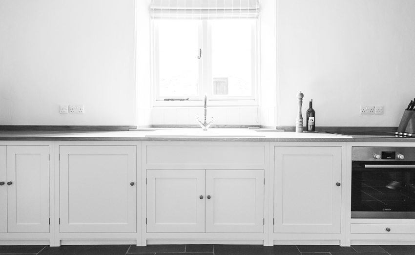 Shaker style kitchen. Birch plywood cabinets with hand painted hardwood frames (Farrow and Ball Estate Eggshell, Pale Powder).Traditional inset sink and integral dishwasher. Inset cooker hob and integral oven. 4.5m full stave oak worktop with upstand. Solid brass hinges and adjustable brass shelf supports. Solid oak dovetailed drawers with painted hardwood fronts. Hand turned beech knobs. Shaker style kitchen. Birch plywood cabinets with hand painted hardwood frames (Farrow and Ball Estate Eggshell, Pale Powder).Traditional inset sink and integral dishwasher. Inset cooker hob and integral oven. 4.5m full stave oak worktop with upstand. Solid brass hinges and adjustable brass shelf supports. Solid oak dovetailed drawers with painted hardwood fronts. Hand turned beech knobs.