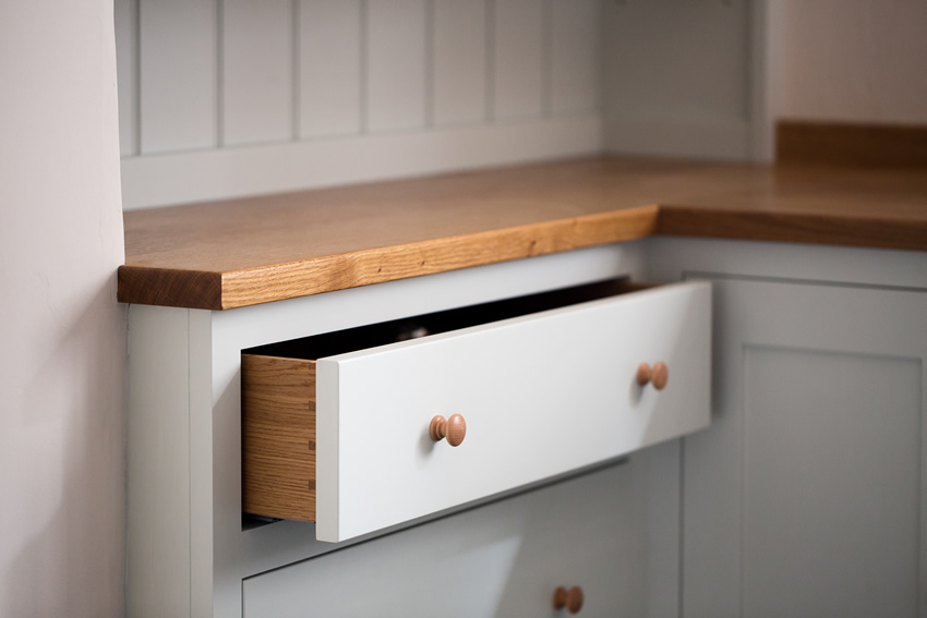 Shaker style kitchen. Birch plywood cabinets with hand painted hardwood frames (Farrow and Ball Estate Eggshell, Pale Powder).Traditional inset sink and integral dishwasher. Inset cooker hob and integral oven. 4.5m full stave oak worktop with upstand. Solid brass hinges and adjustable brass shelf supports. Solid oak dovetailed drawers with painted hardwood fronts. Hand turned beech knobs. Shaker style kitchen. Birch plywood cabinets with hand painted hardwood frames (Farrow and Ball Estate Eggshell, Pale Powder).Traditional inset sink and integral dishwasher. Inset cooker hob and integral oven. 4.5m full stave oak worktop with upstand. Solid brass hinges and adjustable brass shelf supports. Solid oak dovetailed drawers with painted hardwood fronts. Hand turned beech knobs.