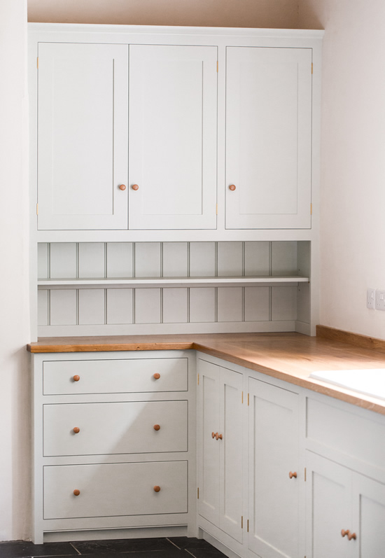 Shaker style kitchen. Birch plywood cabinets with hand painted hardwood frames (Farrow and Ball Estate Eggshell, Pale Powder).Traditional inset sink and integral dishwasher. Inset cooker hob and integral oven. 4.5m full stave oak worktop with upstand. Solid brass hinges and adjustable brass shelf supports. Solid oak dovetailed drawers with painted hardwood fronts. Hand turned beech knobs. Shaker style kitchen. Birch plywood cabinets with hand painted hardwood frames (Farrow and Ball Estate Eggshell, Pale Powder).Traditional inset sink and integral dishwasher. Inset cooker hob and integral oven. 4.5m full stave oak worktop with upstand. Solid brass hinges and adjustable brass shelf supports. Solid oak dovetailed drawers with painted hardwood fronts. Hand turned beech knobs.
