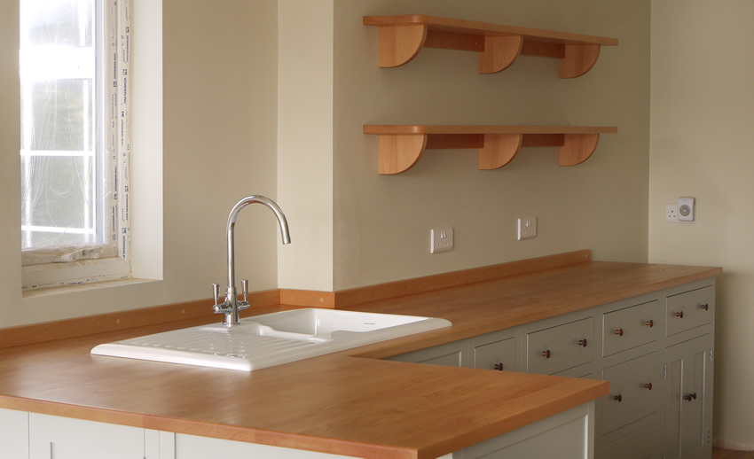 Shaker style kitchen. Birch plywood cabinets with hand painted hardwood frames (Farrow and Ball, Lamp Room Gray). Sink area with integral dishwasher, traditional ceramic inset sink and full stave beech top and upstand. Dovetailed drawers made of solid beech with painted hardwood fronts and walnut hand turned knobs. Shaker style kitchen. Birch plywood cabinets with hand painted hardwood frames (Farrow and Ball, Lamp Room Gray). Sink area with integral dishwasher, traditional ceramic inset sink and full stave beech top and upstand. Dovetailed drawers made of solid beech with painted hardwood fronts and walnut hand turned knobs.