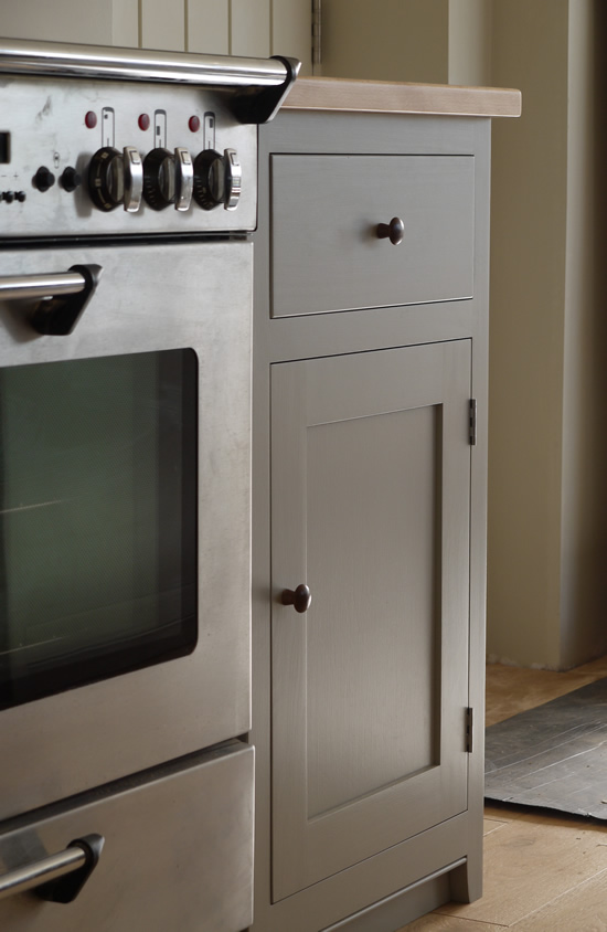 Shaker style kitchen. Birch plywood cabinets with hand painted hardwood frames (Farrow and Ball, Lamp Room Gray). Sink area with integral dishwasher, traditional ceramic inset sink and full stave beech top and upstand. Dovetailed drawers made of solid beech with painted hardwood fronts and walnut hand turned knobs. Shaker style kitchen. Birch plywood cabinets with hand painted hardwood frames (Farrow and Ball, Lamp Room Gray). Sink area with integral dishwasher, traditional ceramic inset sink and full stave beech top and upstand. Dovetailed drawers made of solid beech with painted hardwood fronts and walnut hand turned knobs.