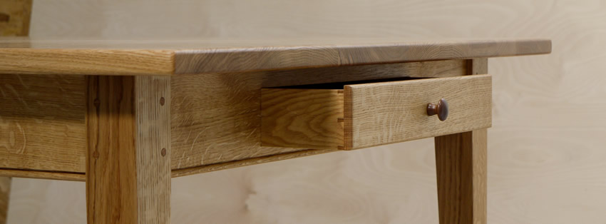 Oak Shaker style table with tapered legs and oak dovetailed drawer. The table is finished with hardwearing 'Osmo' hardwax oil. Oak Shaker style table with tapered legs and oak dovetailed drawer. The table is finished with hardwearing 'Osmo' hardwax oil.