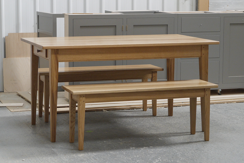 'Shaker style' oak kitchen/dining table with tapered legs & 2 matching benches. 2 oak dovetailed drawers with hand-turned walnut knobs.