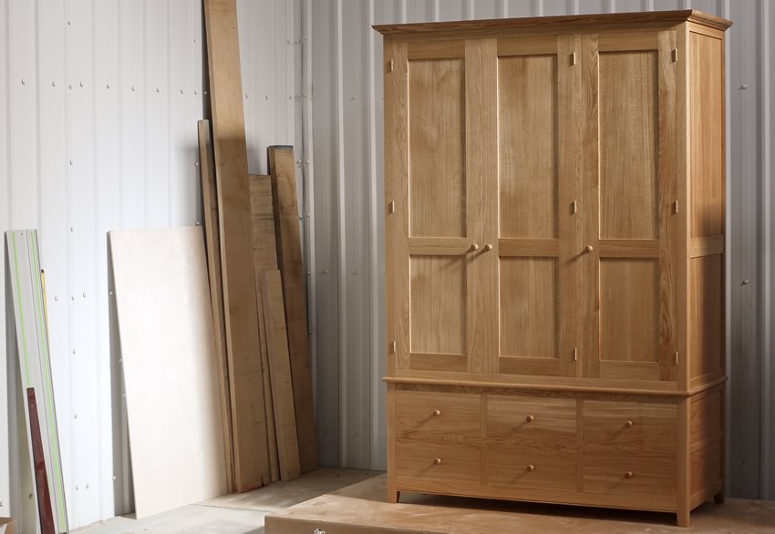 Oak wardrobe with solid oak carcass and panels. Oak faced birch ply shelves. Dovetailed oak drawers on high quality soft close runners. Bespoke cornice in solid oak and hand turned oak knobs. Solid brass hinges and adjustable shelf supports. Oak wardrobe with solid oak carcass and panels. Oak faced birch ply shelves. Dovetailed oak drawers on high quality soft close runners. Bespoke cornice in solid oak and hand turned oak knobs. Solid brass hinges and adjustable shelf supports.
